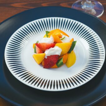 fresh fruit on a black and white plate