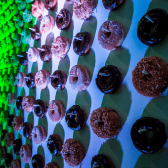a wall full of donuts on sticks