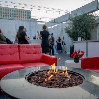 rooftop patio with red couches and fire pit