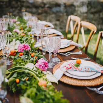 rectangle table with patterned napkins and floral arrangements