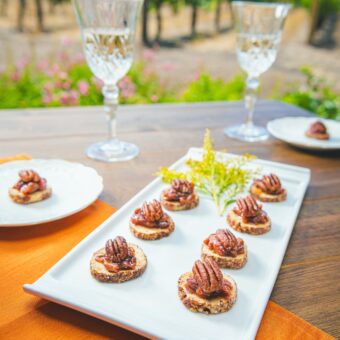 plate with pecan appetizers and glasses of water