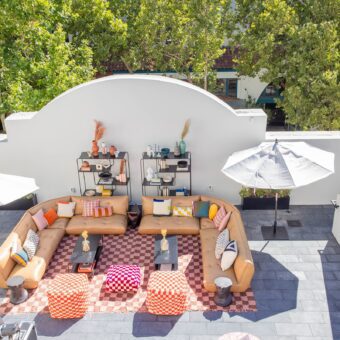 overhead view of rooftop lounge with tan and gray modern furniture