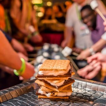 tray with stacked smores held up in front of people