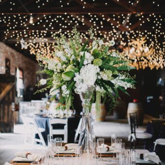 rustic square table setting inside of barn